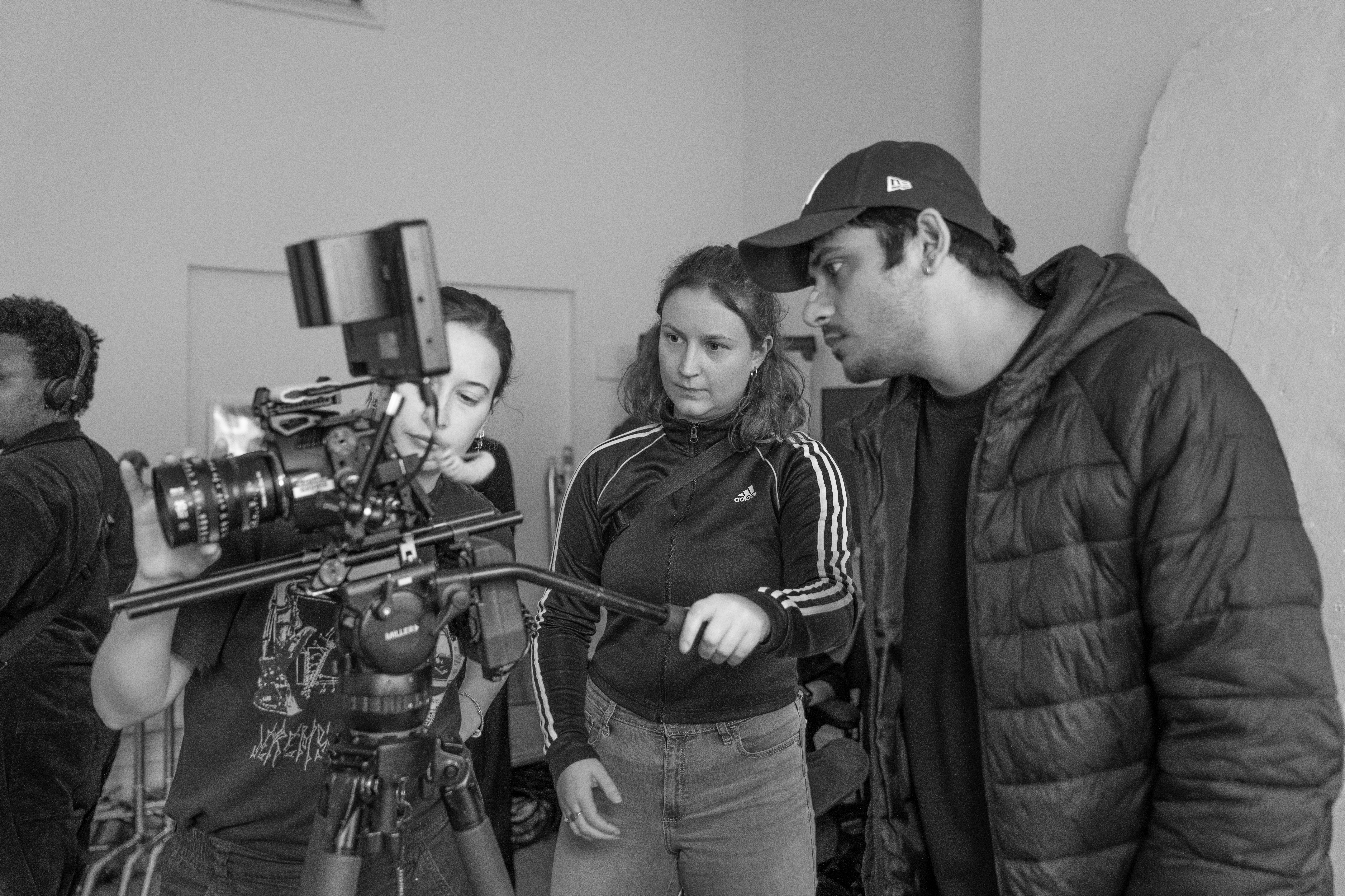 Operators looking at film camera